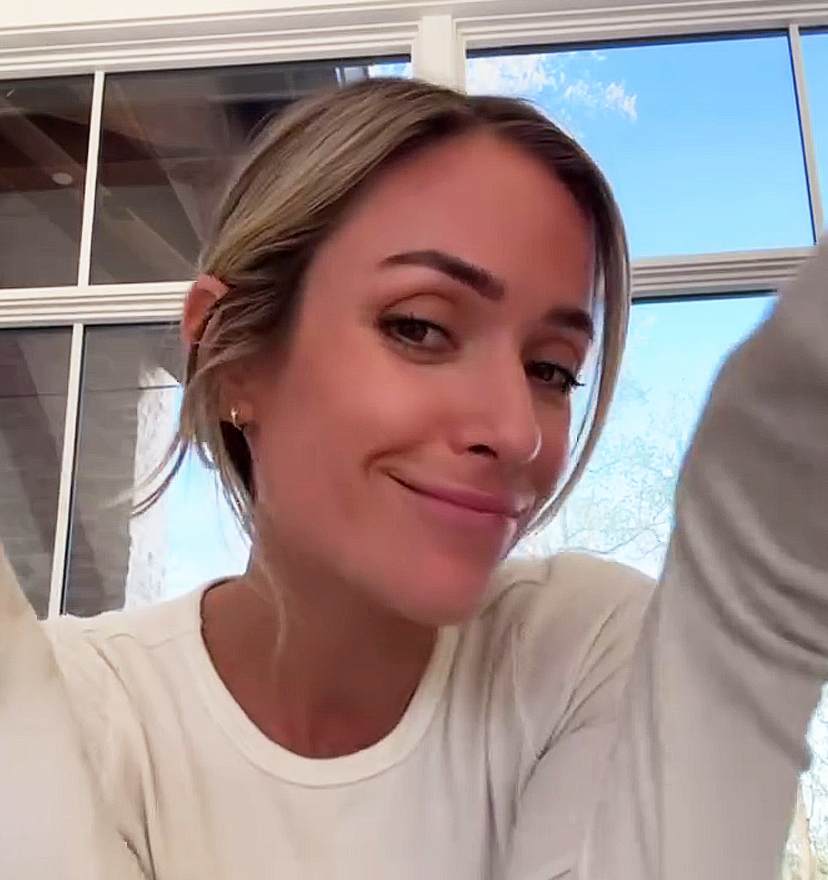 Kristin wears a long-sleeve white top and blue graphic sweatpants on Instagram Stories